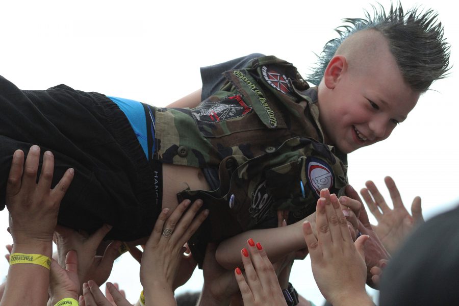 Kid+with+a+mohawk+crowd+surfed+at+the+Back+to+the+Beach+event+in+Huntington+Beach%2C+CA.+He+smiles+as+he+is+being+passed+on+person+to+person.+Photo+credit%3A+Andy+Lizarraga%2F+SAC.Media.
