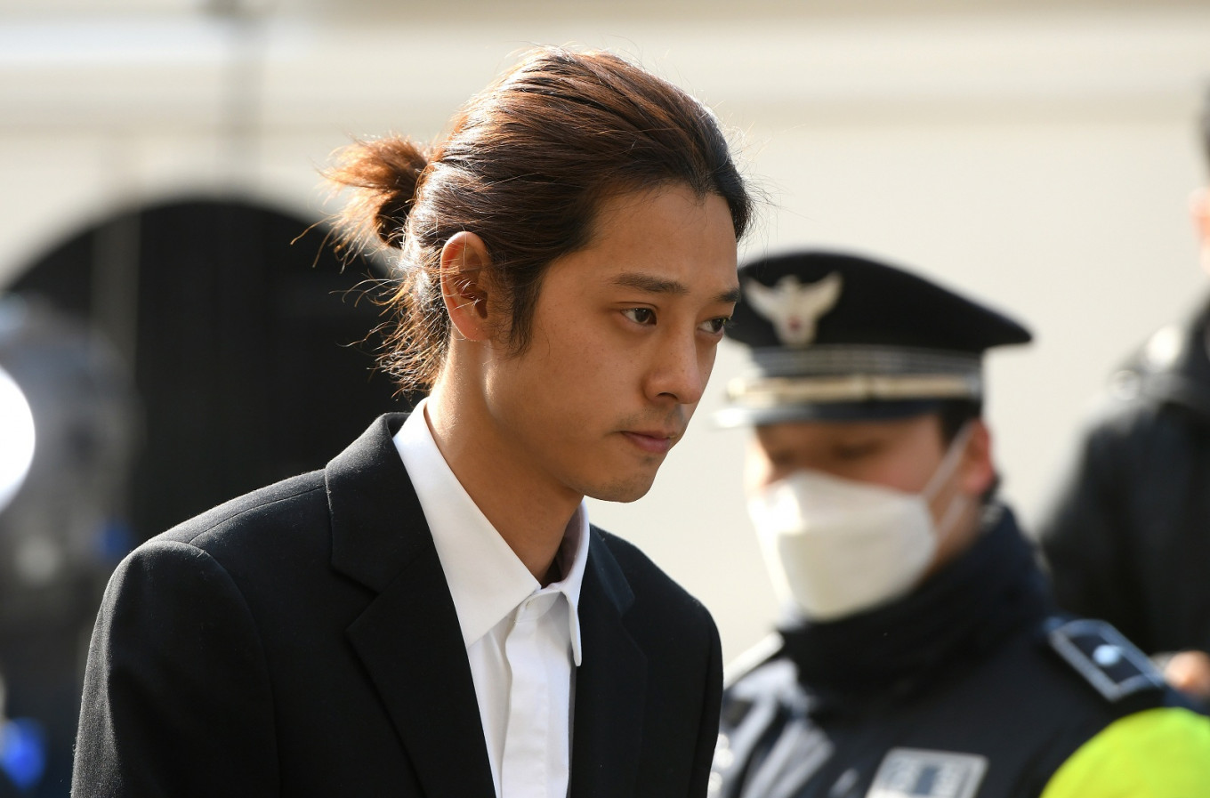 K-pop star Jung Joon-young (C) arrives for questioning in Seoul