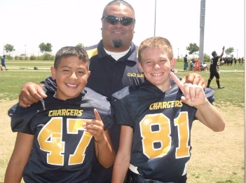 Jon Schofield at age 11 with his youth league football coach Harry and teammate Skylar Salva. Photo courtesy of Jon Schofield.