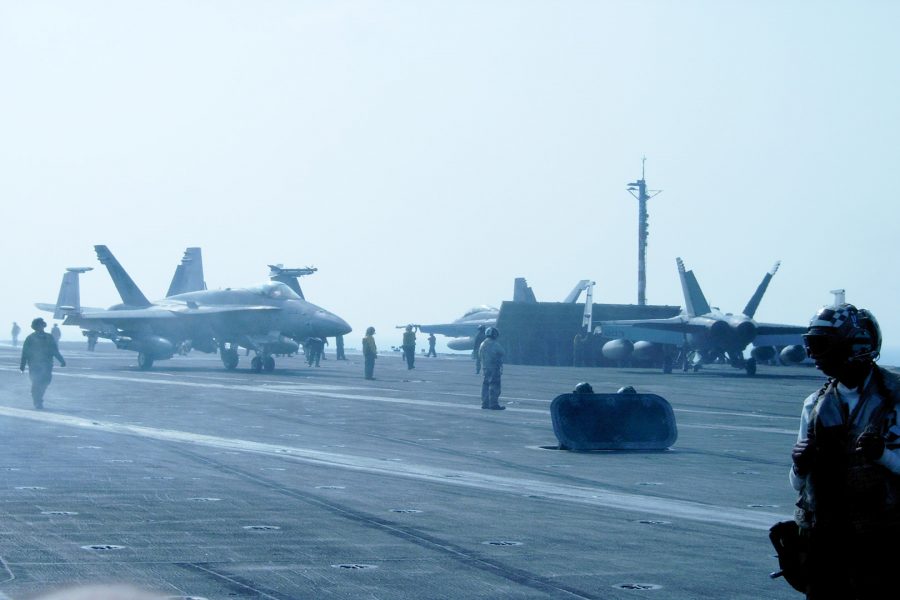 F/A-18 jets prepare to launch off the flight deck of USS Kitty Hawk (CV 63) for training missions in the  South Pacific Ocean during summer deployment in 2005. Photo Credit: Hernandez Coke/Sac.Media