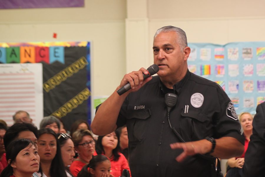 Officer Robert Barba calls order at the Wedgeworth Elementary School multi purpose room on Sept. 14, 2019. Several attendees had stormed off and been raising their voices up to this point. Photo credit: Abraham Navarro/SAC.Media