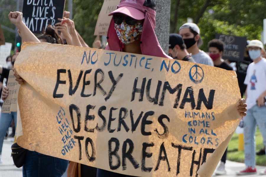 A demonstrator holds up a sign to protest police brutality and the death of George Floyd in Walnut on June 1, 2020. Photo Credit: Audrey Parayno/Contributing Photographer for SAC.Media.