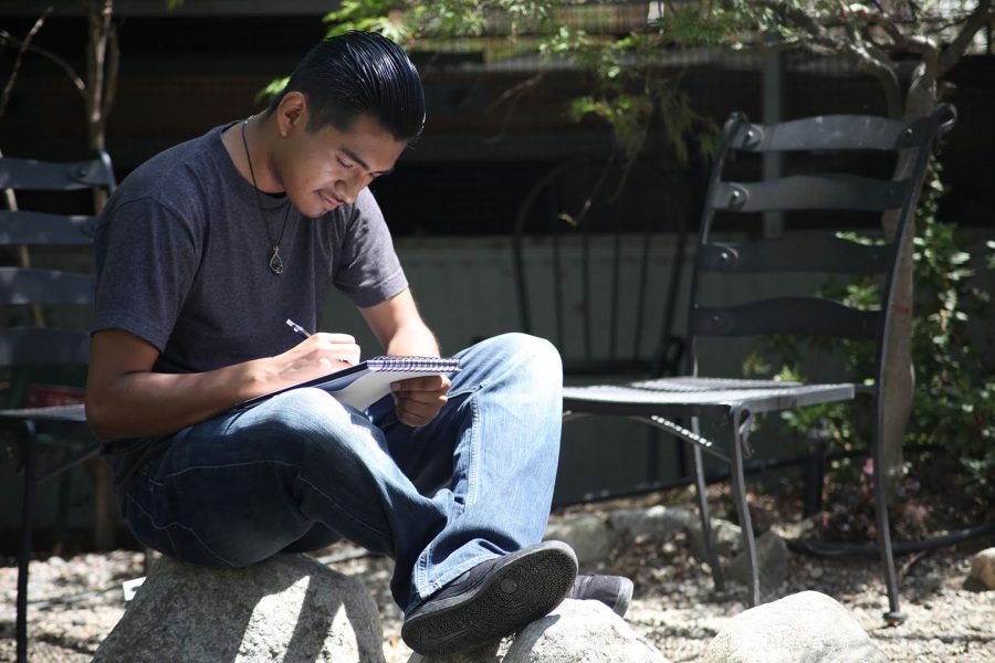 Hector Campos, 20, student, sketches fish at the Mt. SAC koi pond on June 5. Photo credit: Abraham Navarro/SAC.Media.