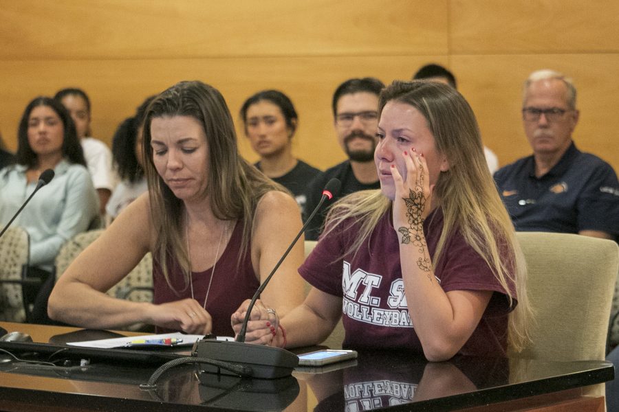 Mt. SAC womens volleyball player Elizabeth Thomas (right) speaks in support for Coach Ali Carey-Oliver (left) as they hold hands during the Board of Trustees meeting on Feb. 26. Photo Credit: Shannon Carter/SAC.Media.