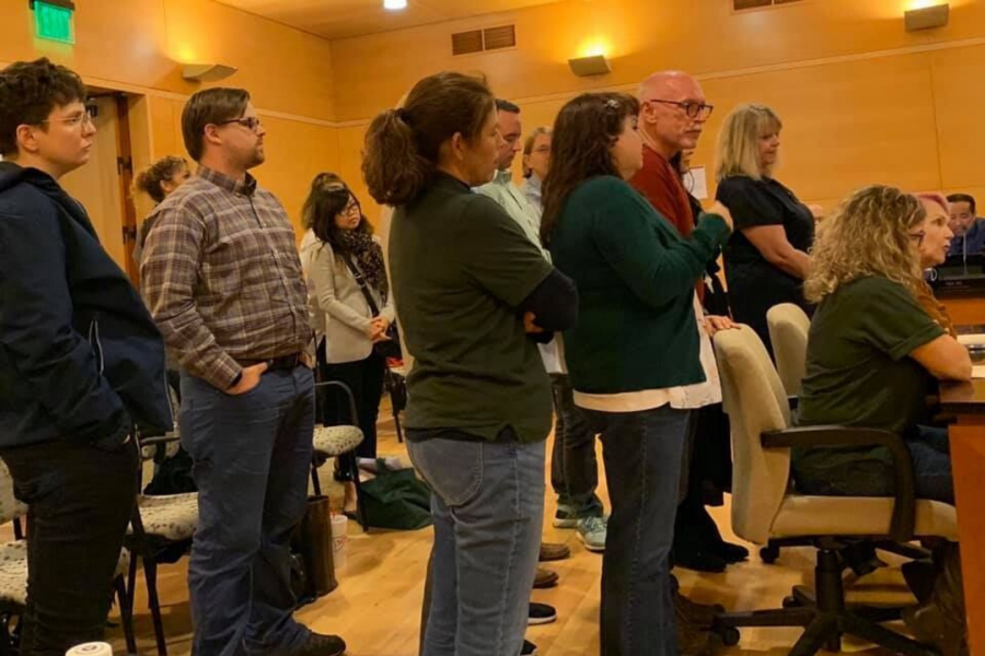 Faculty members stand as Faculty Association President Joan Sholars gives her report before the Board of Trustees on March 13, 2020. Photo courtesy of Emily Woolery.