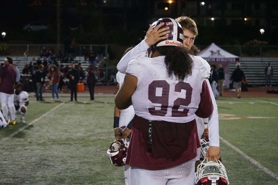 Quarterback Zachary Rangel and defensive lineman Inoke Katoa move in for a hug after a 48-0 loss against Riverside Community College on Saturday, Nov. 23. Photo by Andre Tinoco/SAC.Media