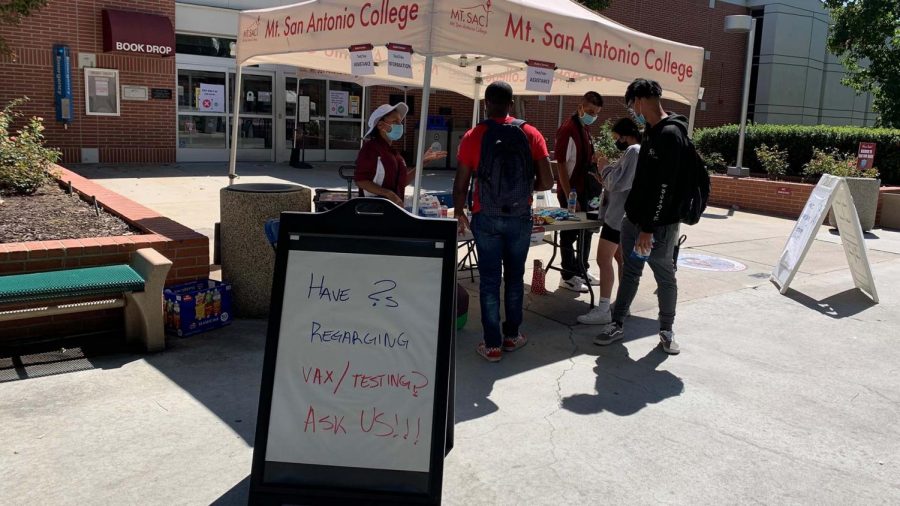 Students ask questions at an information booth outside the Mt. SAC library on Sept. 21.