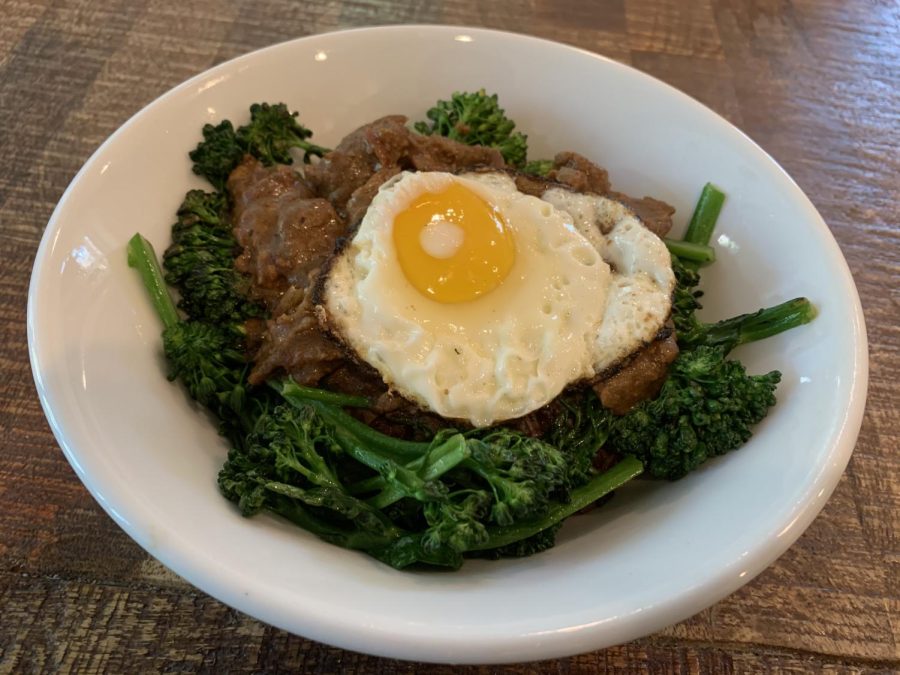 Grandmas fried rice with broccolini and topped with a sunny-side-up for early dinner at home.