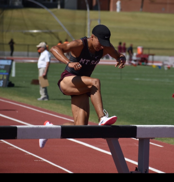 Andrew Villeda jumping the hurdle in the steeplechase event at the Mt. SAC Relays on April 9.