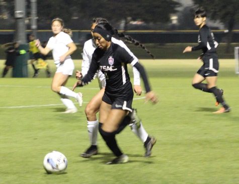 Sophomore midfielder Kaylee Gutierrez (8) pushing the ball down the field with sophomore forward Ayuka Toshimoto (9) trailing the play.