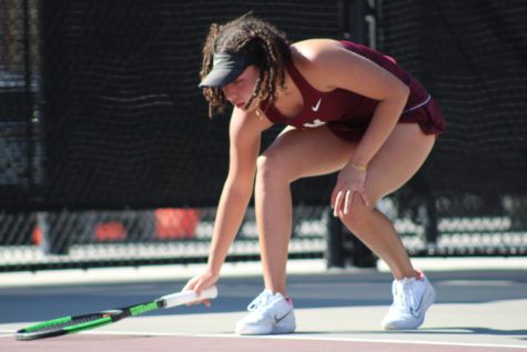 Laced up and locked in, freshman Jahday Drewery resets in between sets during her singles match for the Mounties.