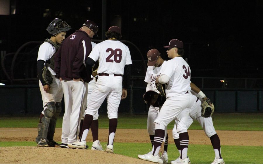 Coach+and+Mounties+gathered+up+around+the+mound+after+freshman+pitcher+Jake+Mitchell+%2828%29+struggled+to+close+out+the+inning.