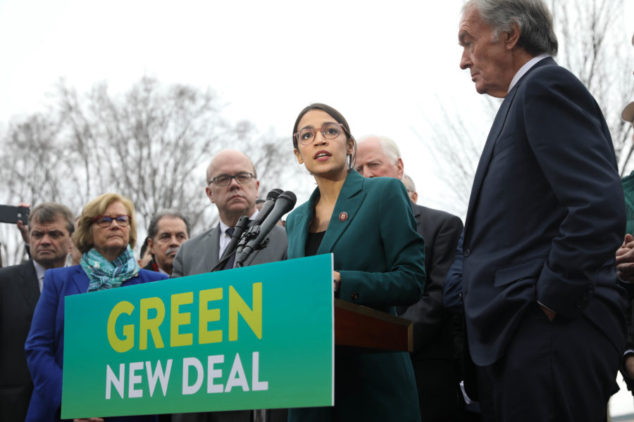 Rep.. Alexandria Ocasio-Cortez (center) and Sen. Edward J. Markey (right) speak on the Green New Deal in front of the Capitol building on February 2019. Via Wikimedia Commons.