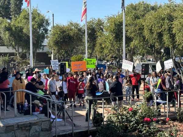 Parents and community members gather at La Puente Park to speak out against school closures.