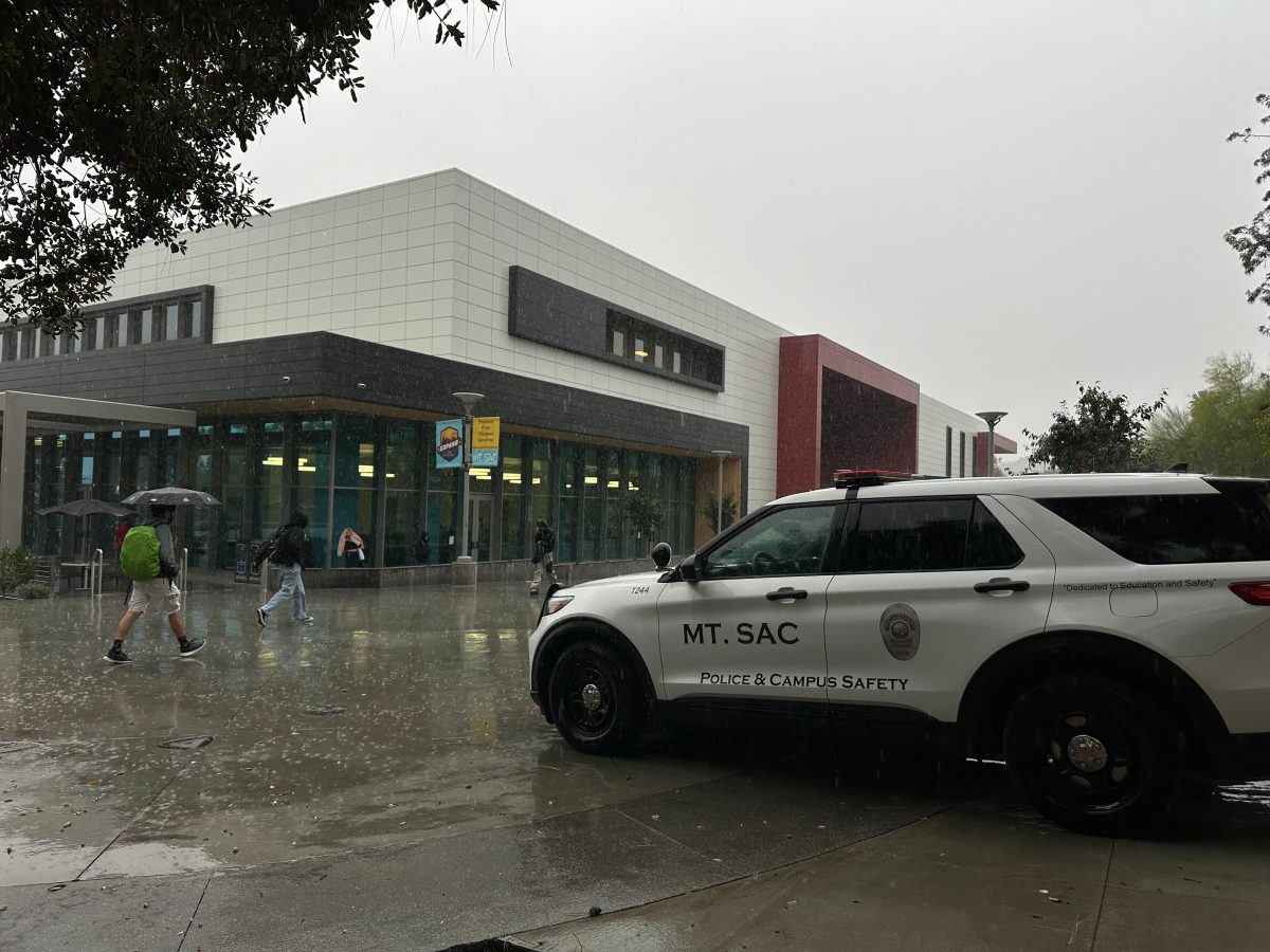 Police and Campus Safety vehicle parked at Miracle Mile on a rainy day.