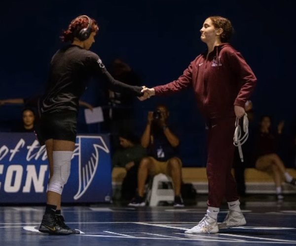 On April 22, 2023, moments before competing in her CCCAA State Championship match, Ruby Rivas shares a moment of sportsmanship with Cerritos Falcons freshman Sabrina Sinohui at 109 lbs. 