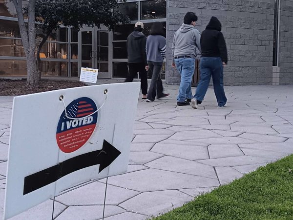 Outside of Cameron Park Community Center in West Covina, clusters of locals arrive to cast their votes for the upcoming elections.