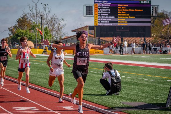 Matthew Donis celebrating the completion of a race during the 3C2A state championships at Saddleback College. 