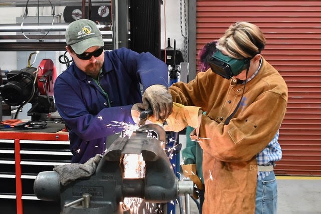 Joshua Christ teaching a Mt. SAC student how to plasma cut through steel. (Joshua Christ)