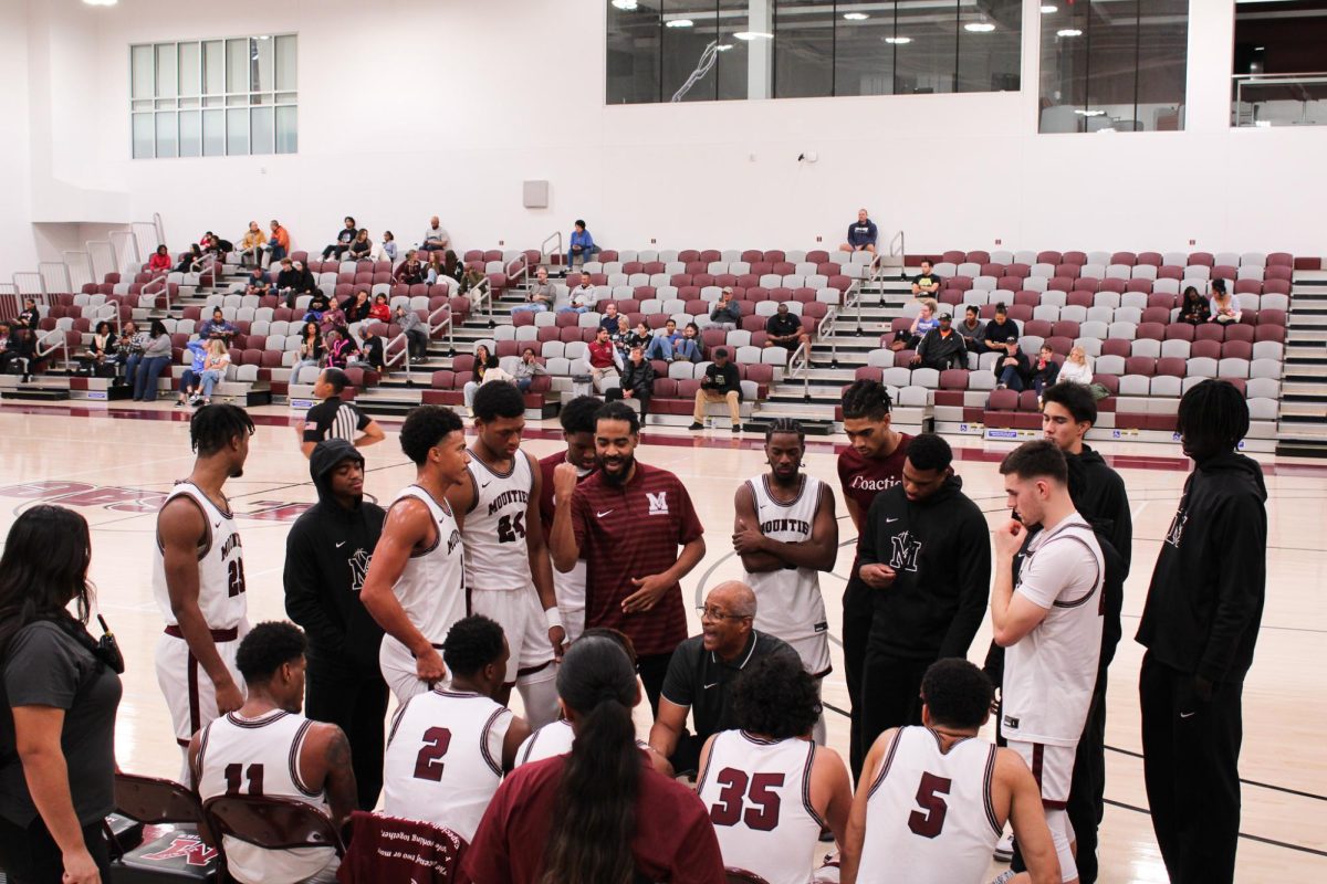 Head coach Michael Fenison and assistant coach Phillip Brown giving advice to the team during a timeout