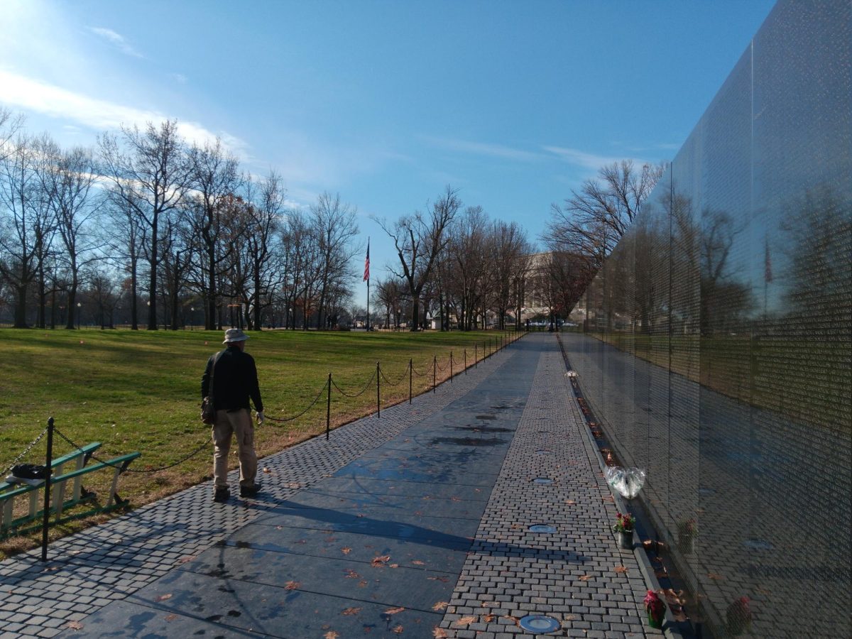 Les Davidson, A Vietnam veteran and a volunteer, walks along the cobble stone path next to the Vietnam Veterans Memorial. 