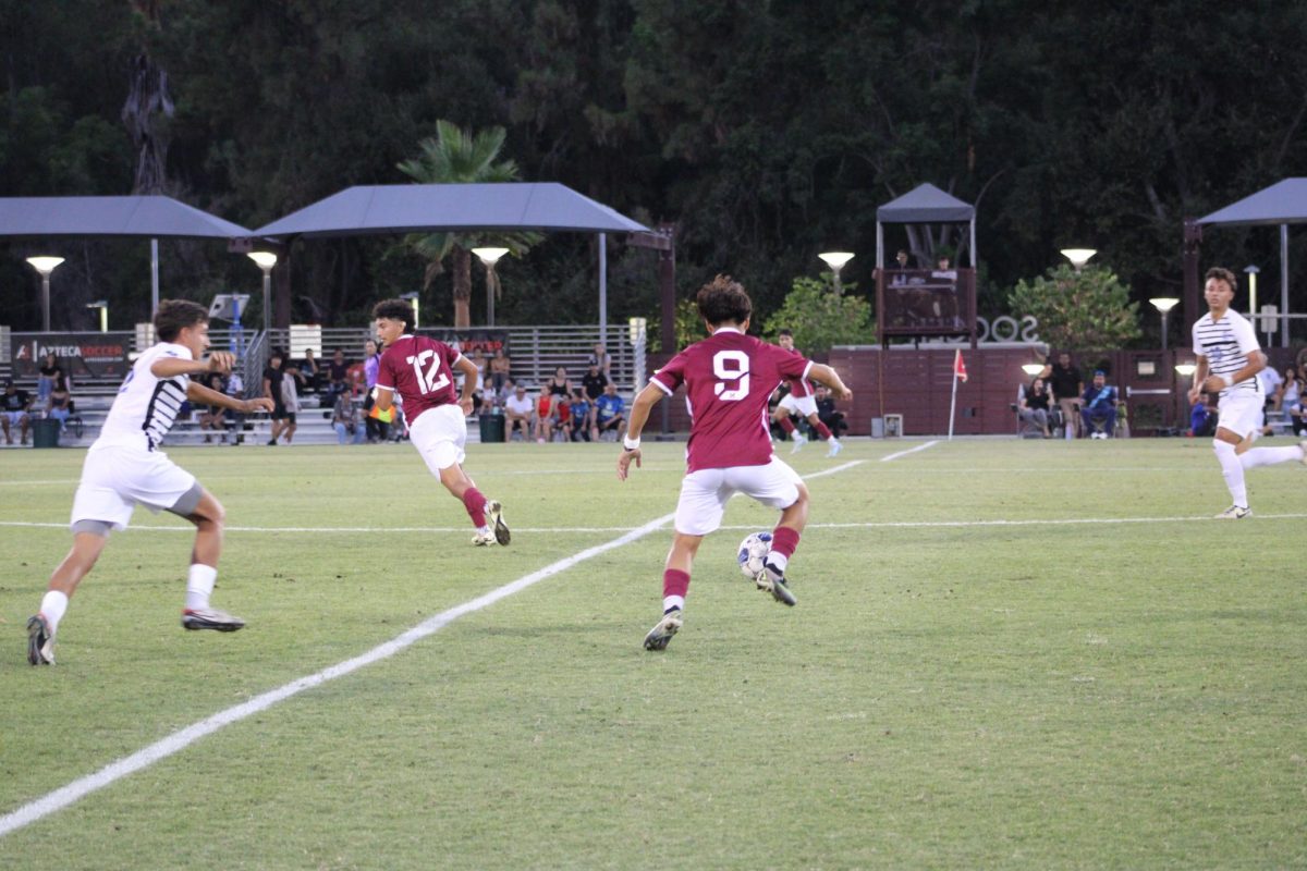 Moises Prado (9) driving towards the goal box.