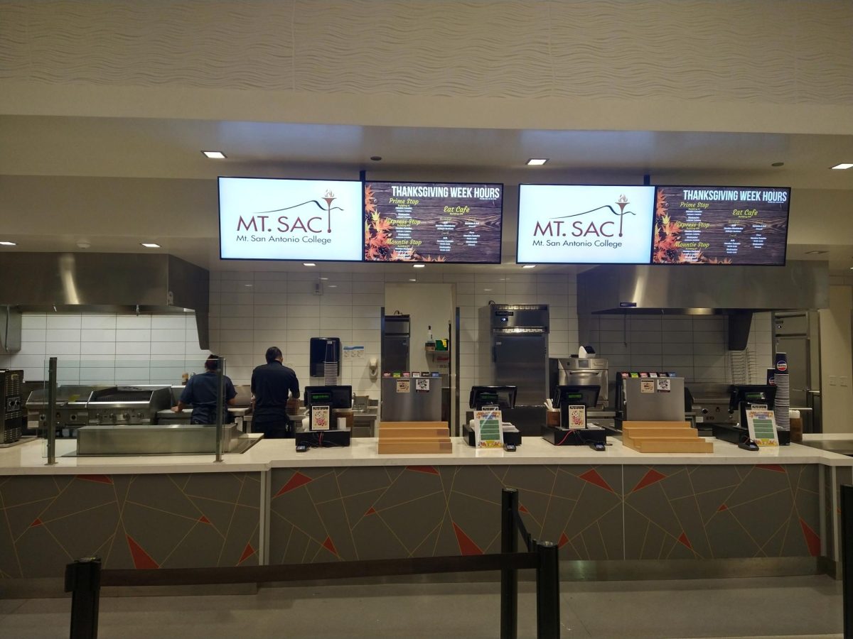 Two Eat Café workers clean the food preparation area after a day of serving students.