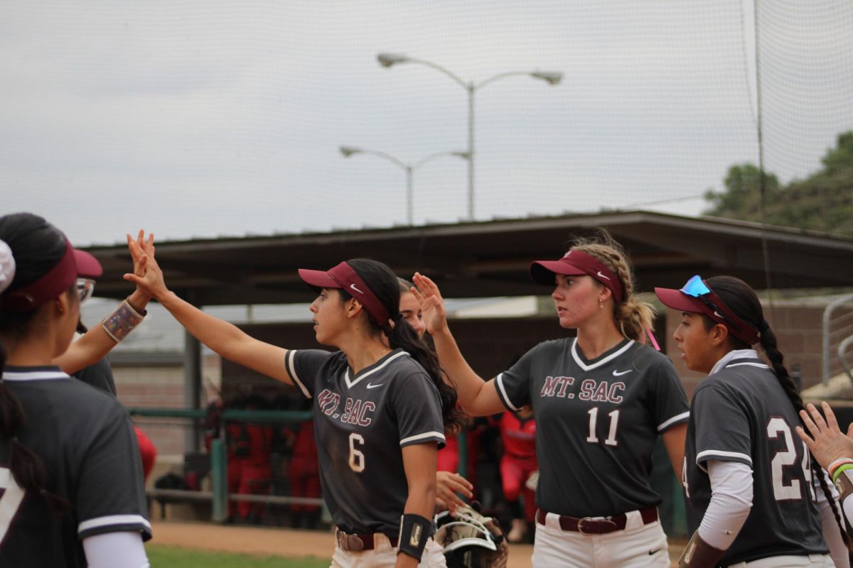 Griego (6), Orozco (24), and White (11) celebrate with the team.
