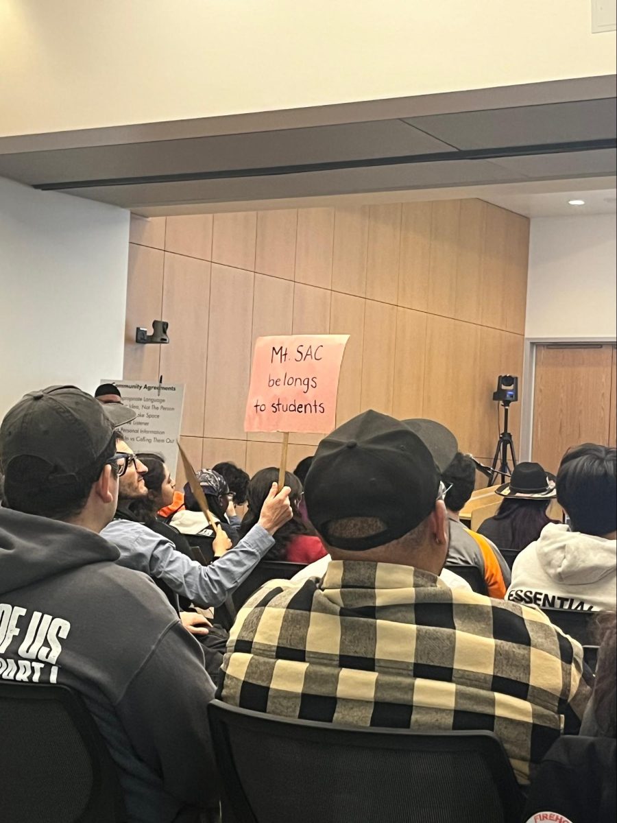 A student holds up a sign in protest of AR-15s on campus