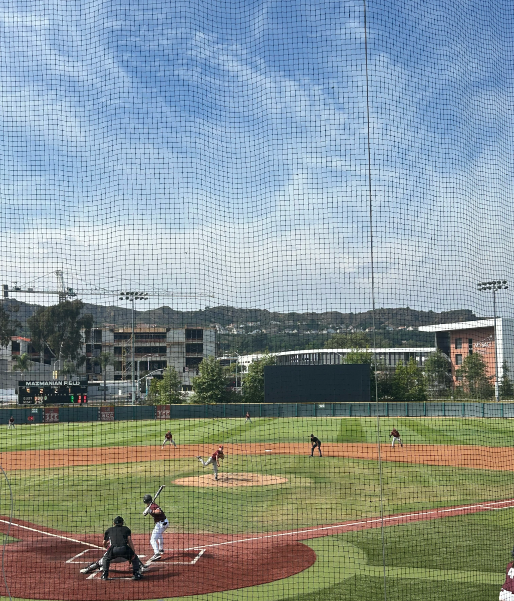 SAC player winds up for the swing at bat while the Glendale Vaqueros pitch
