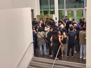Film makers and members of the audience gather outside the auditorium in building 13 after a viewing od student films. 