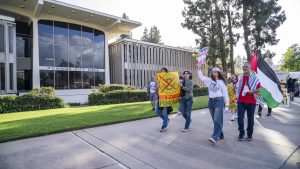 Marchers make their way past Pomona City Hall, transforming public space into a site of protest as they call for city officials to cut ties with federal immigration agencies.