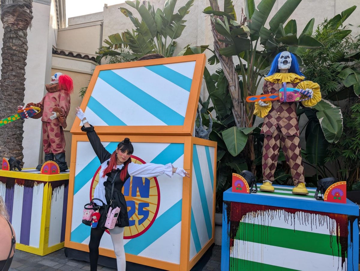 Lucy posing in front of a clown monument in Universal Studios Halloween Horror Nights