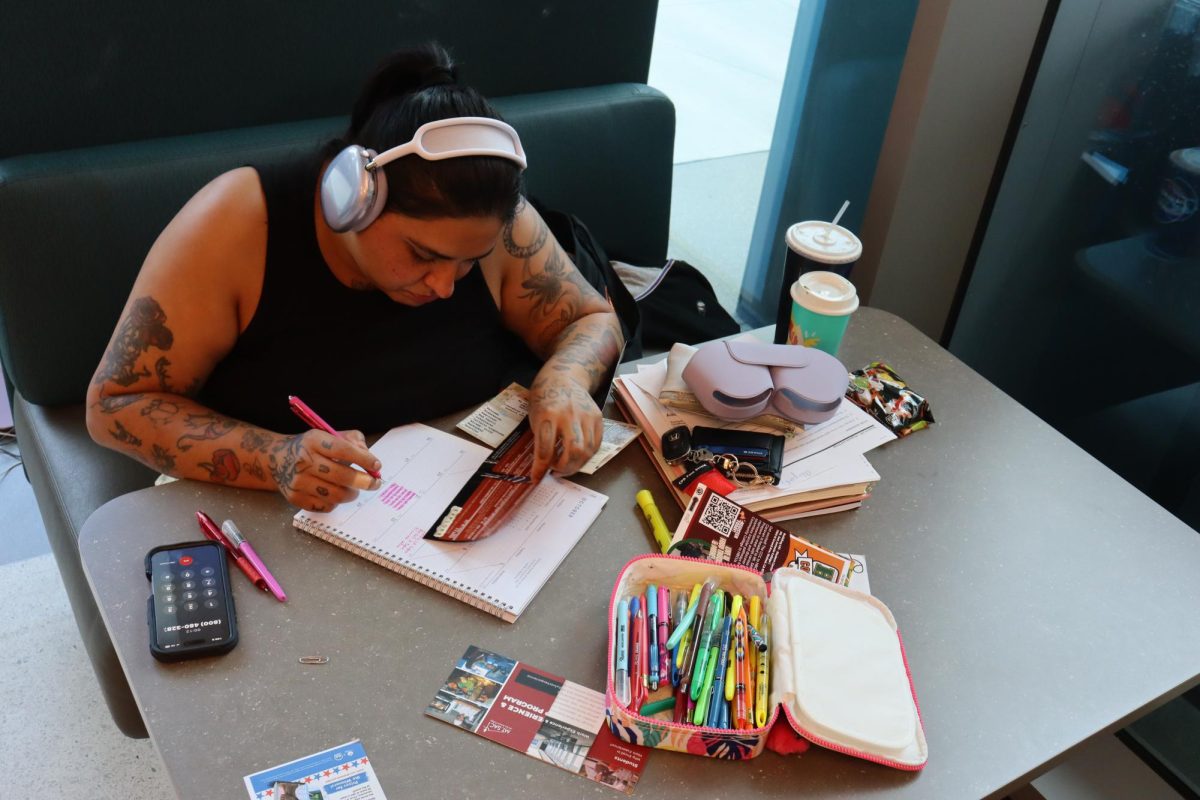 Psychology major Alyssa Delay, 28, uses her free time to study for midterms while also organizing upcoming student events in her calendar to stay balanced and engaged.