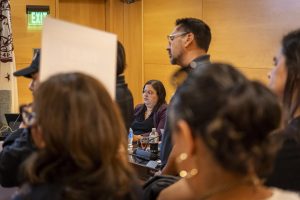 Vice President of Student Services Melba Castro listens as faculty and staff speak during public comment in Founders Hall while speakers criticized leadership and called for accountability.