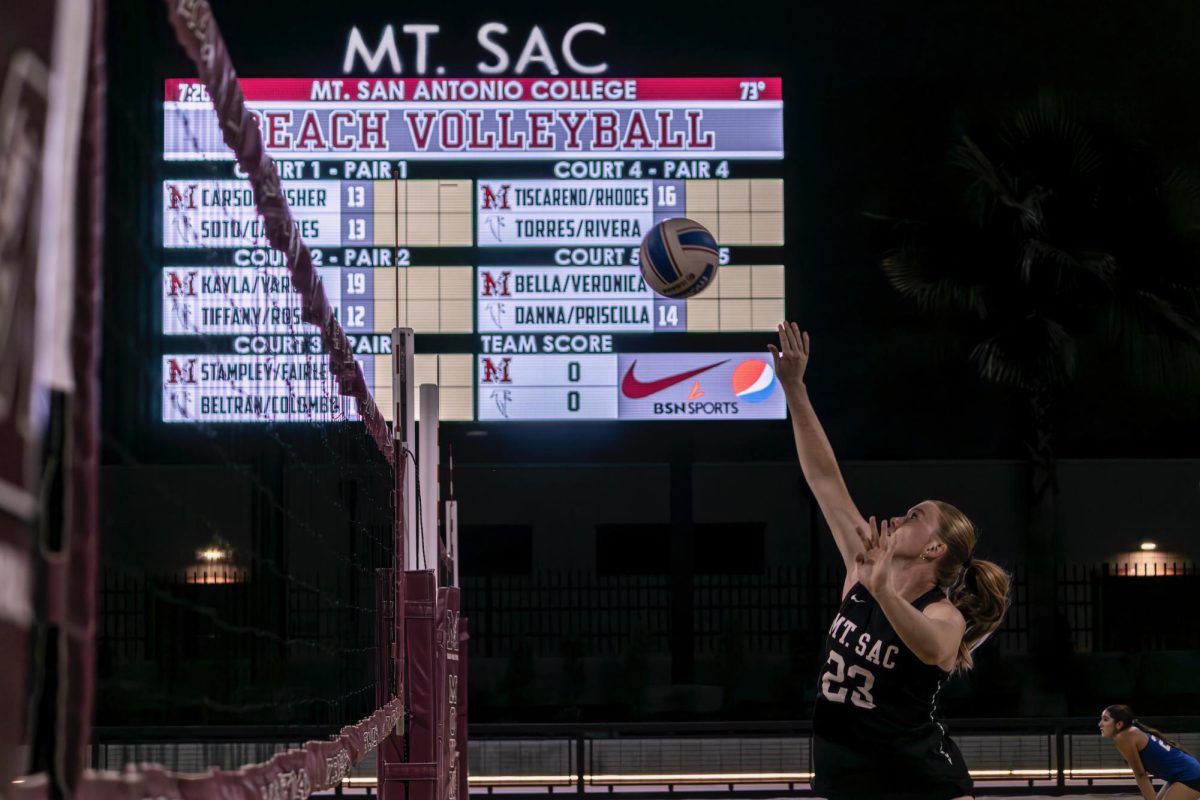 Jeanie Rhodes (23) spikes the ball over the net during the first set of the second match.