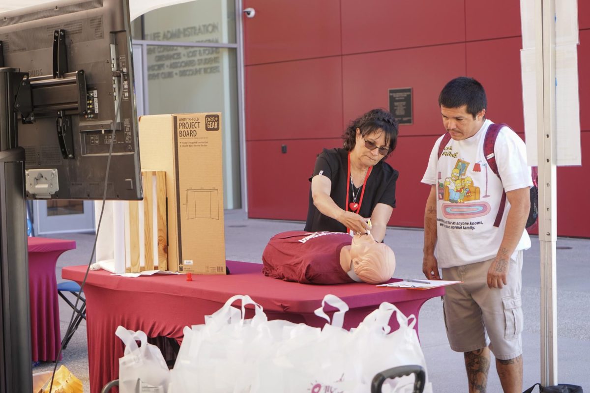 Samaris Alvarado, Medical Assistant demonstrating to a student on how to use narcan on a medical dummy. 